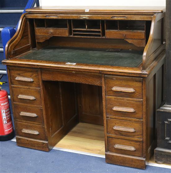 A T. Dobson & Son of Leeds oak tambour top desk W.120cm